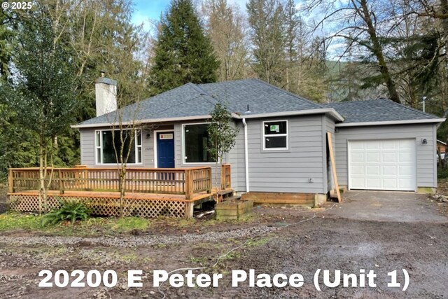 20220 E Peter Pl Unit 3, Sandy, OR 97055 - view of front of property featuring a chimney, a garage, roof with shingles, a wooden deck, and asphalt driveway