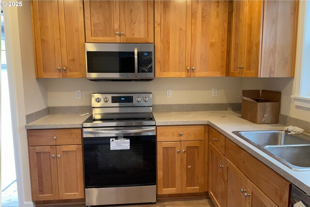 20220 E Peter Pl Unit 3, Sandy, OR 97055 - unfurnished living room with a ceiling fan, wood finished floors, baseboards, and a fireplace