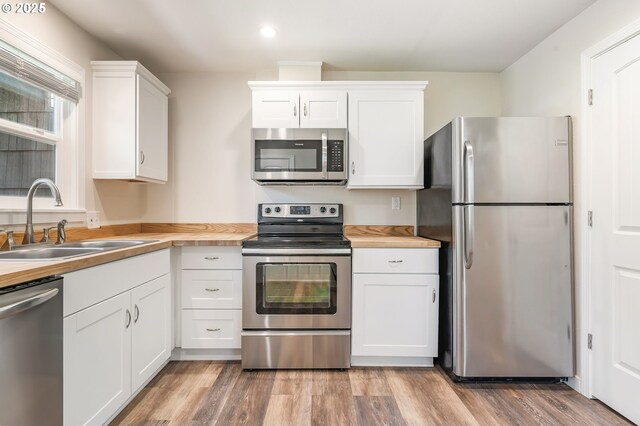 20220 E Peter Pl Unit 3, Sandy, OR 97055 - kitchen with appliances with stainless steel finishes, a sink, white cabinetry, light wood-style floors, and recessed lighting