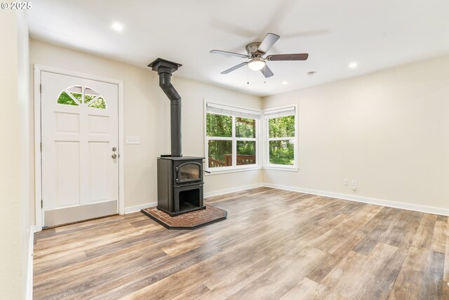 20220 E Peter Pl Unit 3, Sandy, OR 97055 - unfurnished living room with a wood stove, plenty of natural light, ceiling fan, light wood-style flooring, and recessed lighting