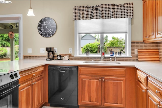 kitchen with dishwasher, a sink, light countertops, and decorative backsplash