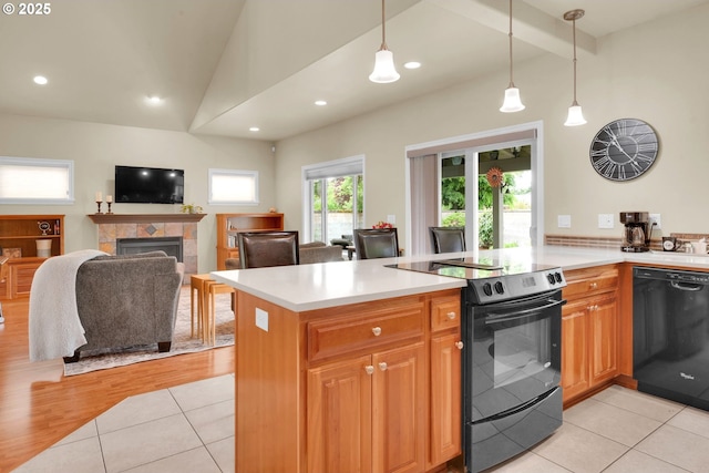kitchen featuring black appliances, a fireplace, light tile patterned floors, light countertops, and recessed lighting