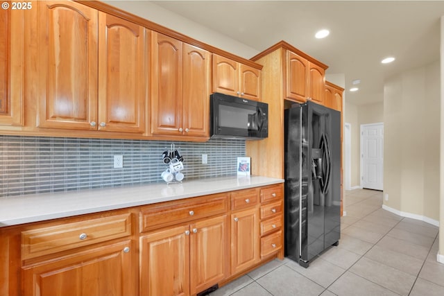 kitchen with black appliances, decorative backsplash, light tile patterned floors, and recessed lighting