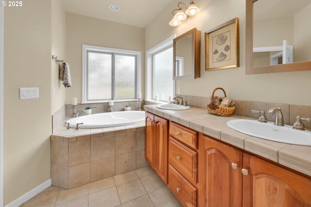 bathroom with a garden tub, double vanity, and tile patterned flooring