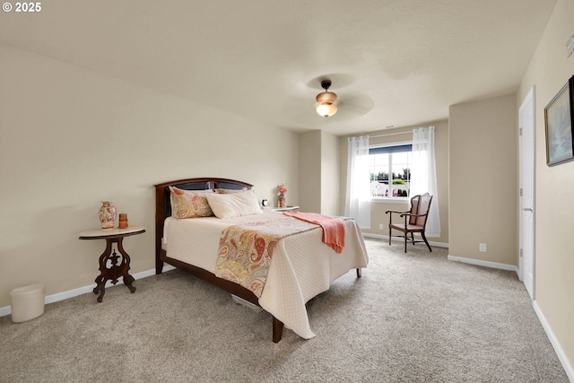 carpeted bedroom featuring baseboards and a ceiling fan