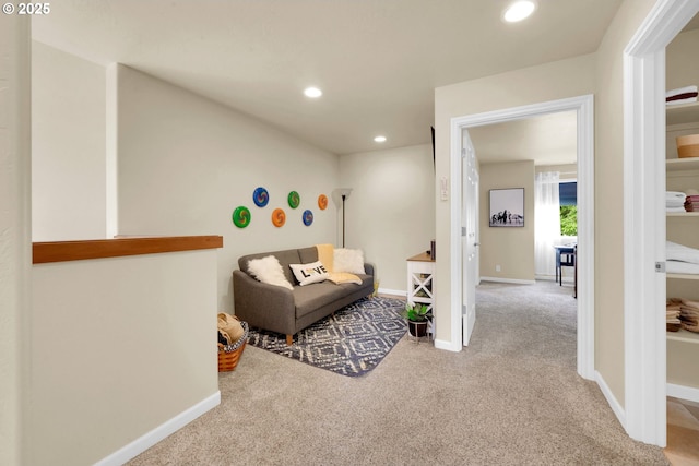 sitting room with carpet flooring, recessed lighting, and baseboards