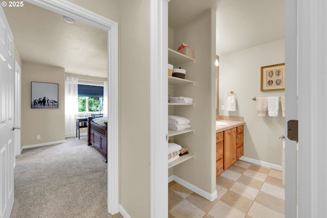 bathroom with vanity and baseboards