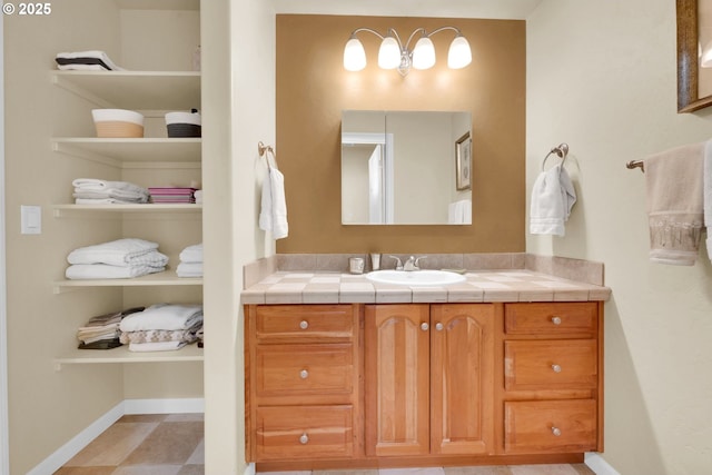 bathroom with vanity and baseboards