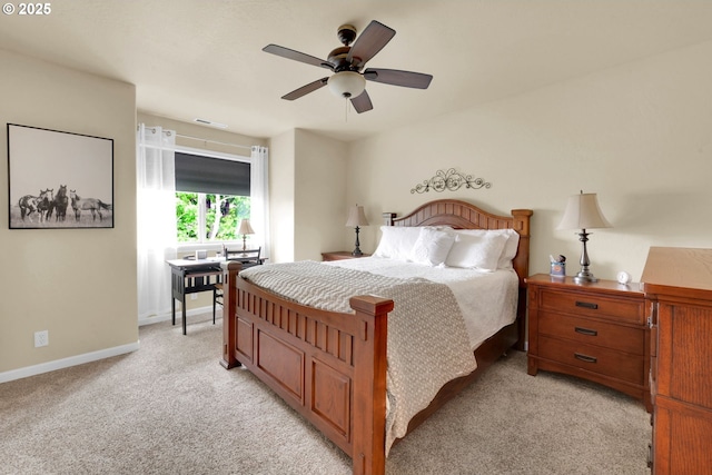 bedroom featuring light carpet, baseboards, and ceiling fan