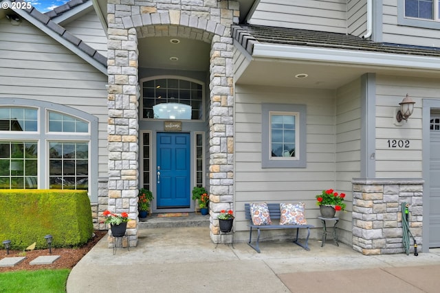 view of exterior entry featuring stone siding
