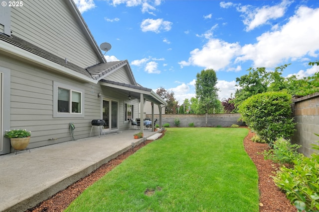 view of yard featuring a patio area and ceiling fan