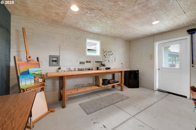 misc room with concrete floors, plenty of natural light, recessed lighting, and a workshop area