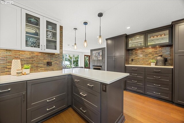 kitchen featuring backsplash, light countertops, and wood finished floors