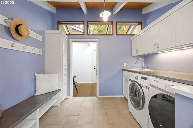 clothes washing area with separate washer and dryer, wood ceiling, light tile patterned flooring, a sink, and cabinet space