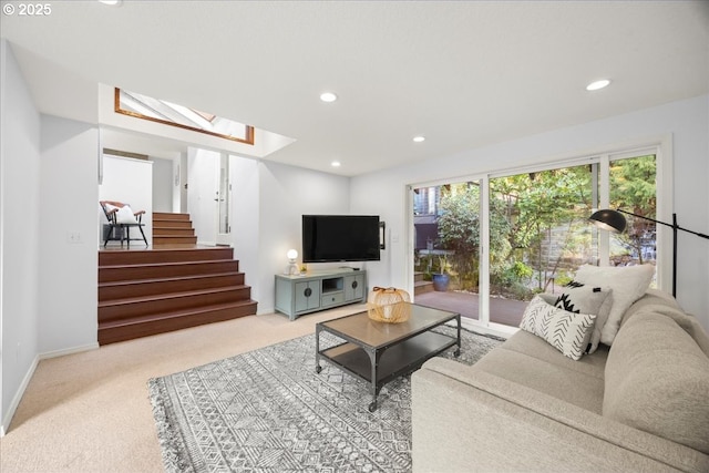 carpeted living room featuring recessed lighting, baseboards, stairs, and a skylight