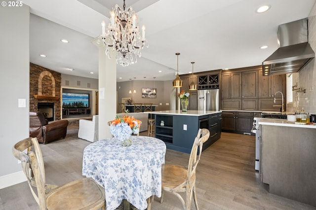 4706 NE 137th St, Vancouver, WA 98686 - dining room featuring recessed lighting, light wood-style flooring, a fireplace, and a chandelier