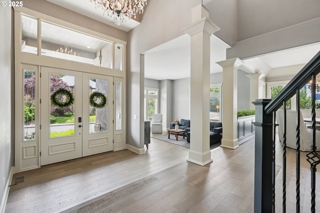4706 NE 137th St, Vancouver, WA 98686 - foyer entrance featuring a chandelier, a towering ceiling, decorative columns, and wood finished floors