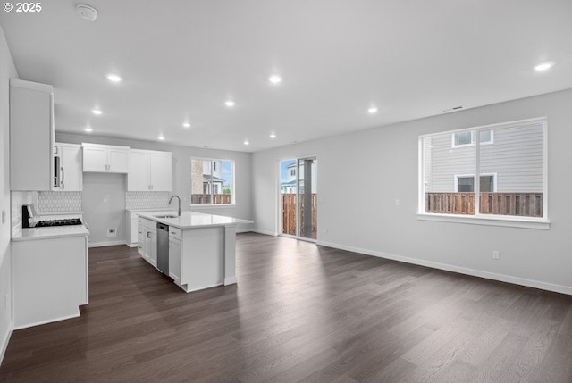 18950 SW Eureka Ln, Beaverton, OR 97007 - kitchen featuring stainless steel dishwasher, range, light countertops, dark wood-style flooring, and recessed lighting
