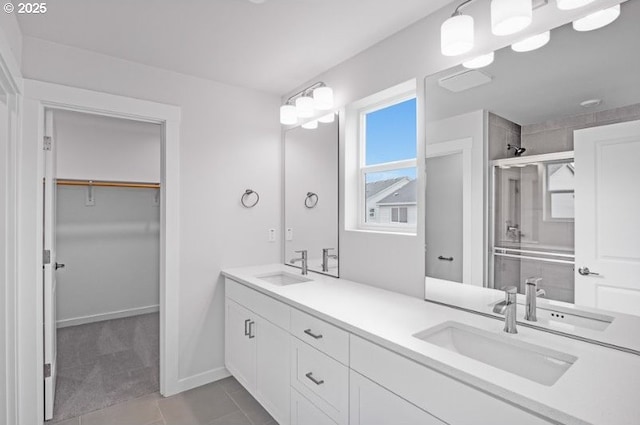 18950 SW Eureka Ln, Beaverton, OR 97007 - bathroom with double vanity, a spacious closet, a shower stall, and tile patterned floors