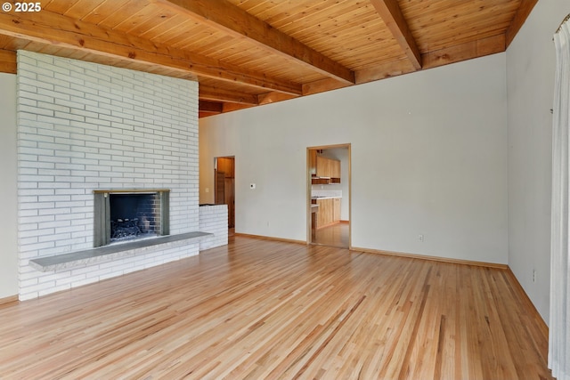 845 NW Day Dr, Gresham, OR 97030 - unfurnished living room featuring wood finished floors, wood ceiling with exposed beams, baseboards, and a brick fireplace