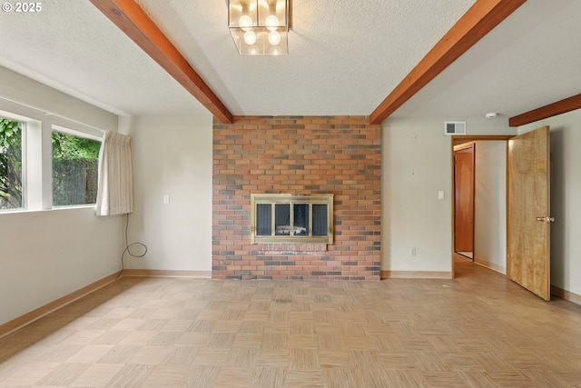 845 NW Day Dr, Gresham, OR 97030 - unfurnished living room with beamed ceiling, a textured ceiling, baseboards, and a fireplace