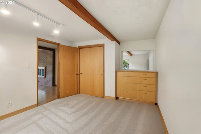 845 NW Day Dr, Gresham, OR 97030 - unfurnished bedroom featuring light colored carpet, baseboards, a large fireplace, a closet, and track lighting
