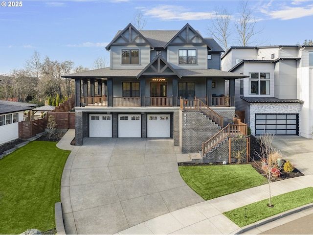 view of front of property with a front yard, a garage, and covered porch