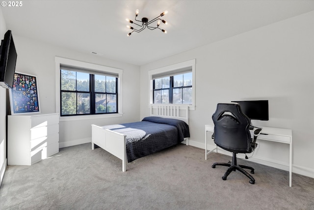 bedroom with light carpet and a chandelier