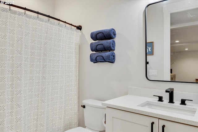 bathroom with toilet, curtained shower, and vanity