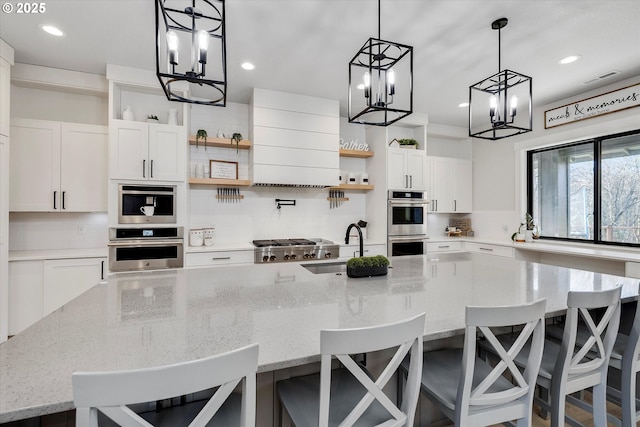 kitchen with white cabinets, sink, backsplash, and a breakfast bar area