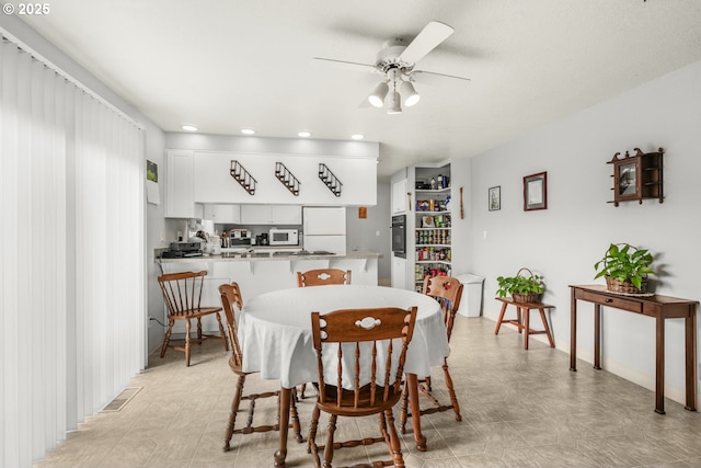 dining room with ceiling fan and recessed lighting