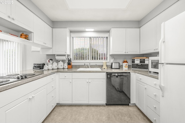 kitchen with white appliances, a sink, white cabinets, and light countertops