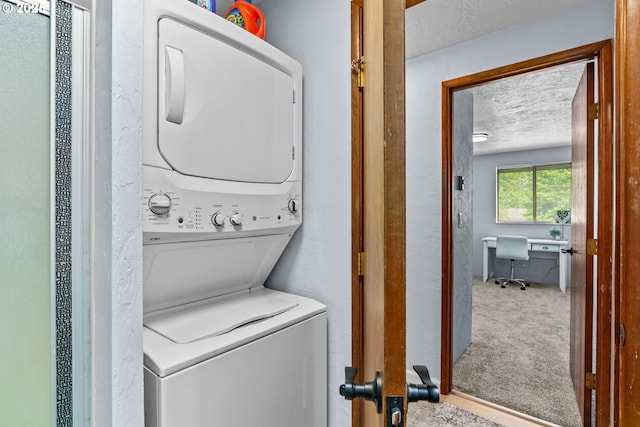 650 Harlow Rd Unit 233, Springfield, OR 97477 - laundry area featuring stacked washing maching and dryer, laundry area, carpet flooring, and a textured ceiling