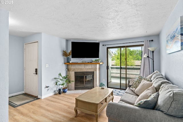 650 Harlow Rd Unit 233, Springfield, OR 97477 - living area featuring a textured ceiling, a fireplace, and wood finished floors