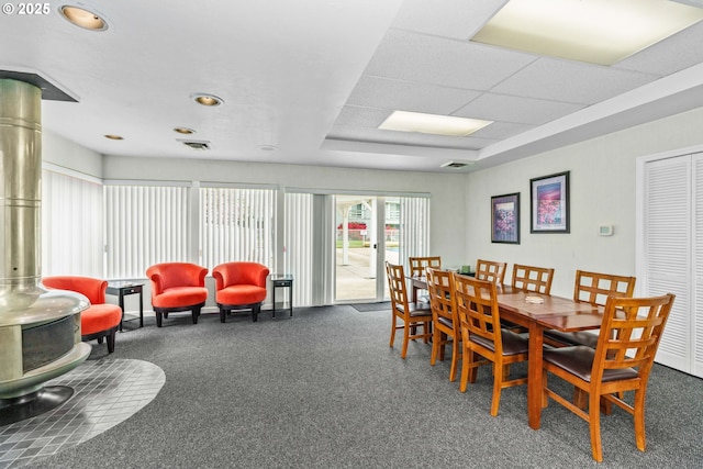650 Harlow Rd Unit 233, Springfield, OR 97477 - dining area with carpet floors, visible vents, and a wood stove