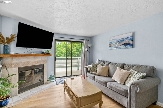 650 Harlow Rd Unit 233, Springfield, OR 97477 - living room featuring a textured ceiling, light wood finished floors, and a fireplace