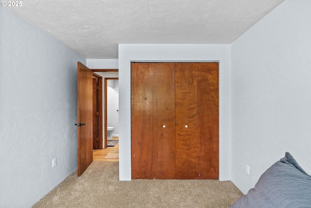650 Harlow Rd Unit 233, Springfield, OR 97477 - carpeted bedroom featuring a textured ceiling and a closet