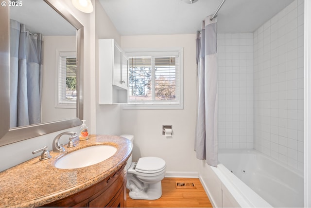 full bathroom featuring hardwood / wood-style flooring, shower / bath combo, a wealth of natural light, and toilet