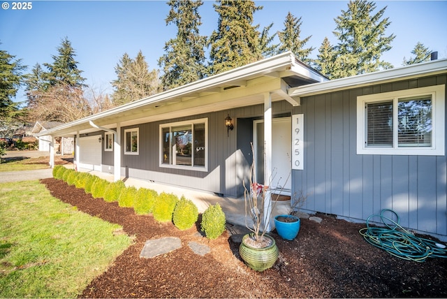 single story home featuring a garage and covered porch