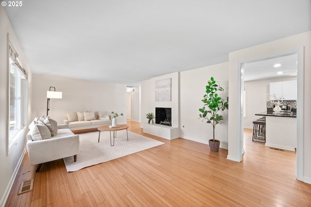 living room with light hardwood / wood-style flooring