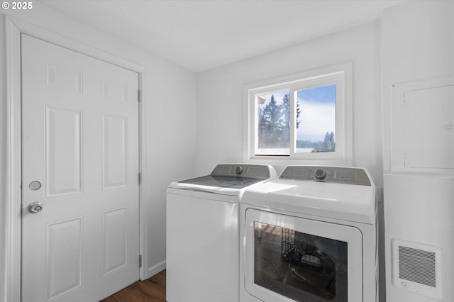 laundry room with separate washer and dryer and dark hardwood / wood-style floors