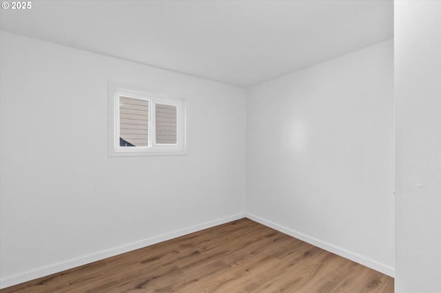 spare room with hardwood / wood-style flooring