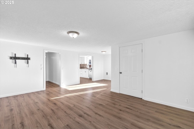 unfurnished room featuring dark hardwood / wood-style floors and a textured ceiling