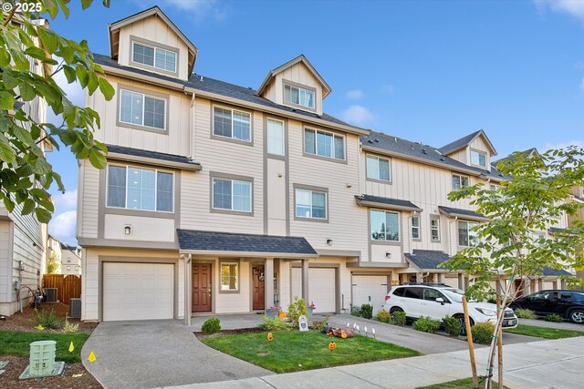 13020 SW Larkwood Pl, Sherwood, OR 97140 - townhome / multi-family property with a garage, driveway, and board and batten siding