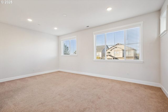 empty room with recessed lighting, baseboards, and light colored carpet