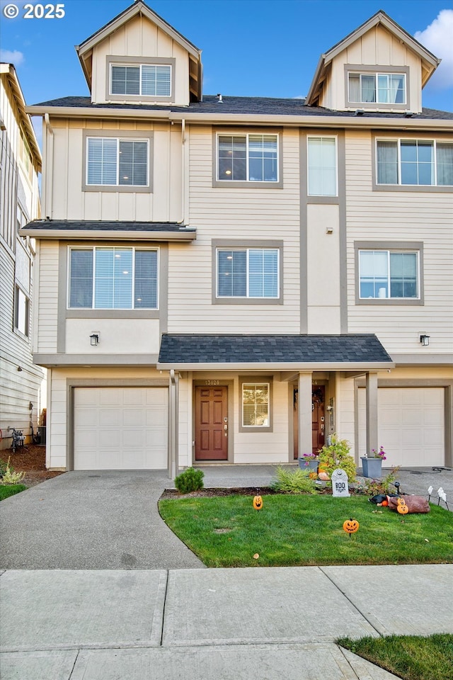13020 SW Larkwood Pl, Sherwood, OR 97140 - view of property featuring board and batten siding, asphalt driveway, a garage, and a front yard