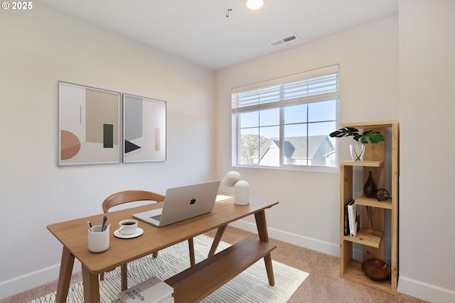 office area featuring baseboards, visible vents, and carpet floors