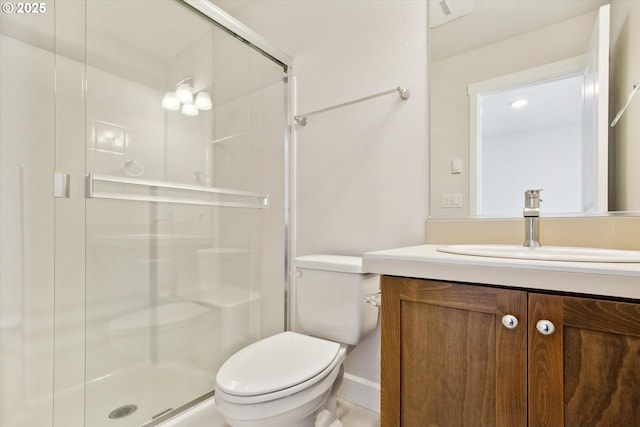 bathroom featuring a stall shower, toilet, and vanity