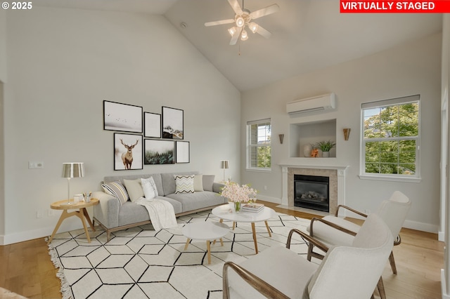 4630 Summerlinn Way W, Linn, OR 97068 - living area with a wall mounted AC, high vaulted ceiling, a fireplace, ceiling fan, and light wood-type flooring