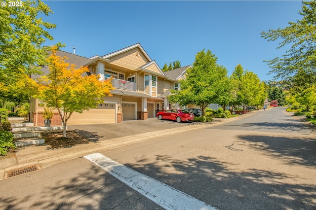 4630 Summerlinn Way W, Linn, OR 97068 - view of front facade featuring a garage, a balcony, driveway, and brick siding
